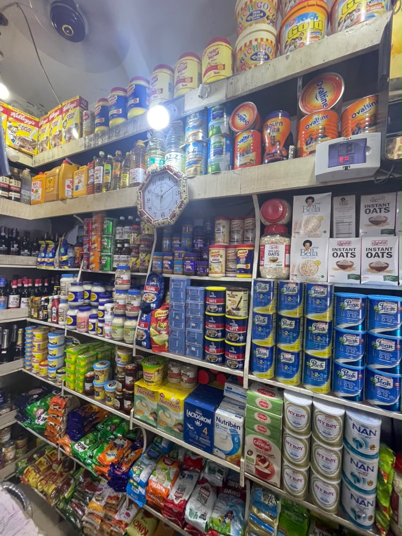 Shelves stocked floor to ceiling with pantry goods and baby formula